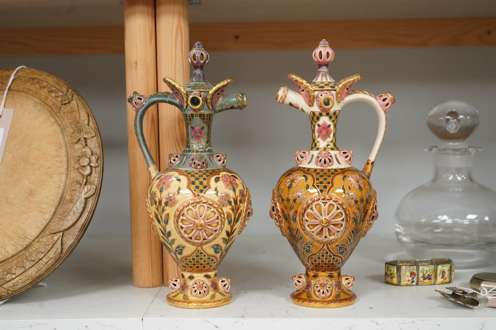 Two Zsolnay Persian inspired jugs / ewers and covers, stamped to the bases 29cm high